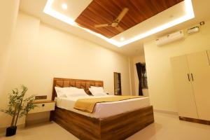 a bedroom with a bed with a ceiling fan at Anand Legacy in Nelamangala