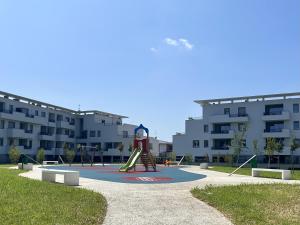 a playground with a slide in front of a building at Malpensa Airport Apartment - 9 min to MXP - Free Parking in Somma Lombardo