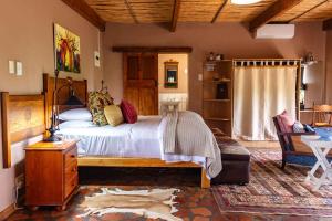 a bedroom with a large bed with a wooden frame at Skeiding Guest Farm in Heidelberg +187 photos