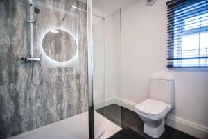 a bathroom with a shower and a toilet at Villa Farm York in York +221 photos