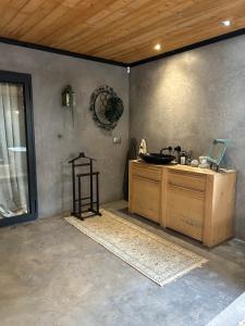 a bathroom with a sink and a wooden ceiling at FollyFoot Manor in Midrand