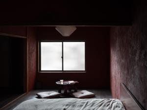 a dark room with a bed and a window at 刷々 sassa in Osaka +18 photos