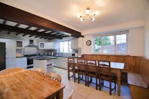 a large kitchen with a wooden table and chairs at Villa Farm York in York