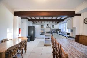 a large kitchen with a wooden table and chairs at Villa Farm York in York