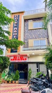 a group of motorcycles parked in front of a building at Hotel Aashirwad in Indore