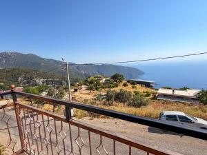 a view of the ocean from the balcony of a house at Alınca Elm Pansiyon in Fethiye