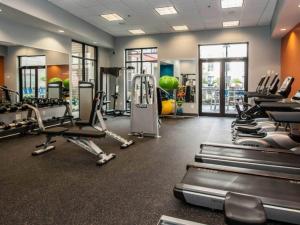 a gym with treadmills and elliptical machines at Luxe Nest King Studio Downtown 2B3 in Birmingham