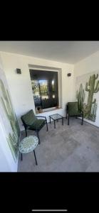 two green chairs and a table in a room at La casa al mare in Palermo