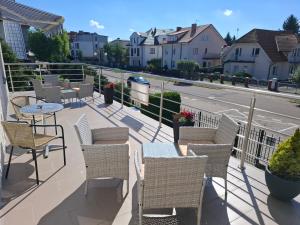 a balcony with chairs and tables and a street at DW Viva in Rewal