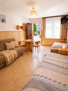 a living room with a couch and a table at DW Viva in Rewal