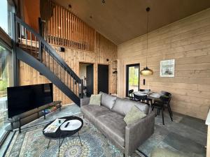 a living room with a couch and a table at Tyven Resort in Sirkkakoski