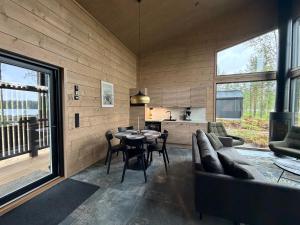a living room with a couch and a table at Tyven Resort in Sirkkakoski