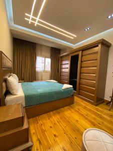 a bedroom with a bed and a wooden floor at Luxury Apartments - Downtown Cairo in Cairo