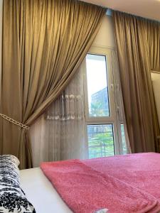 a bedroom with a pink bed and a window at Luxury Apartments - Downtown Cairo in Cairo
