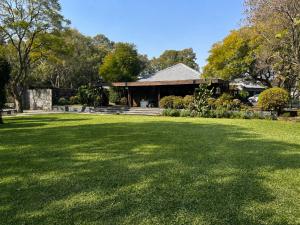 a large lawn in front of a house at FollyFoot Manor in Midrand
