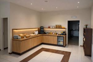 a kitchen with a counter with food on it at HOTEL de la POSTE in Esch-sur-Alzette