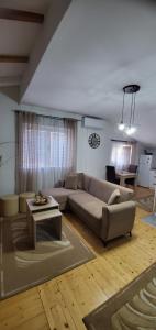 a living room with a couch and a table at Tabia Condo in Ljubuški