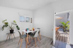 a dining room with a table and chairs and a window at Charmant appartement pour 4 in Saint-Jean-de-Liversay