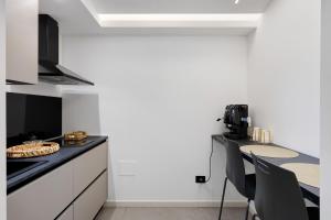 a kitchen with a counter and a table with chairs at La Rocca D’Amuri in Partinico +34 photos