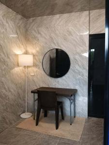 a table with a chair and a mirror on a wall at Lhady Roxy in Siquijor +5 photos