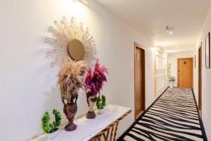 a room with a table with cacti and a mirror at Treebo Premium Widlor Boutique with Swimming Pool in Mumbai