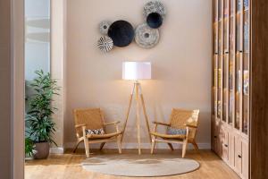 a living room with two chairs and a lamp at INNSiDE by Meliá Costablanca in Benidorm