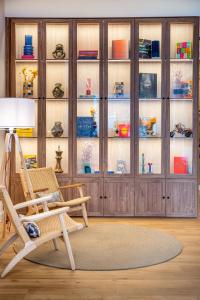 a room with a chair and a cabinet filled with dishes at INNSiDE by Meliá Costablanca in Benidorm