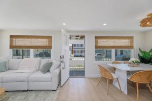 a living room with a white couch and a table at Mermaid Lane #1 in Brighton Beach
