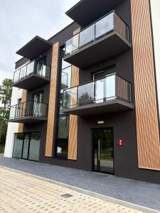 a building with balconies on the side of it at Apartament w Kębłowie in Kębłowo