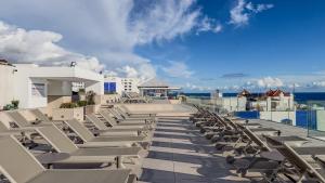 a row of lounge chairs on the roof of a resort at Perla Marina in Nerja