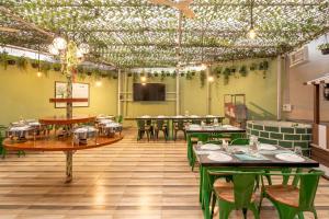 a restaurant with tables and chairs in a room at Treebo Premium Widlor Boutique with Swimming Pool in Mumbai