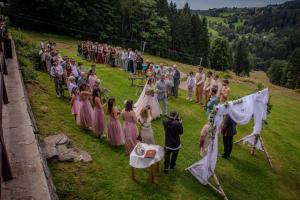 a wedding ceremony on a hill with a group of people at Chata Hubertka Krkonoše in Vítkovice