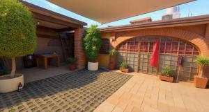 a courtyard with potted plants in front of a building at Mayumi weekend accommodation in Cocoyoc