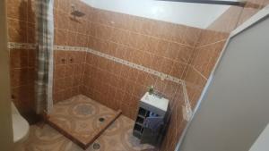 a small bathroom with a shower and a toilet at Mayumi weekend accommodation in Cocoyoc