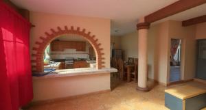 a kitchen with an arch in the middle of a room at Mayumi weekend accommodation in Cocoyoc