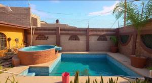 a swimming pool in the backyard of a house at Mayumi weekend accommodation in Cocoyoc