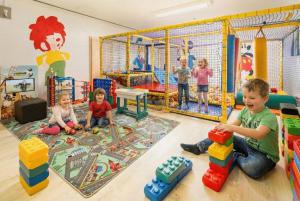 a group of children playing in a play room at Hotel Nummerhof in Erding +59 photos