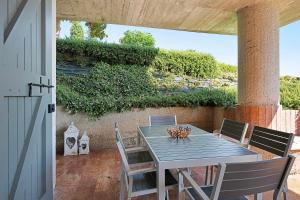 a blue table and chairs on a patio at Appartamenti Villa Andrea in Garda