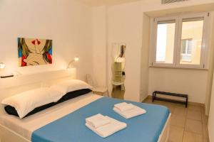 a bedroom with a bed with two towels on it at Appartamenti Giusy e Giusy 2 in Sorrento +27 photos