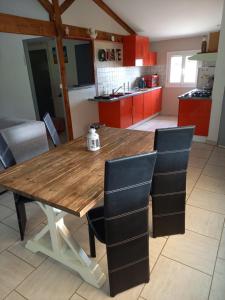 a kitchen with a wooden table and chairs at Gites panoramique in Sainte-Livrade-sur-Lot