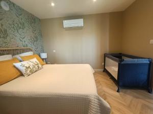 a bedroom with a large bed and a air conditioner at Le jardin de Nigelle , En Provence in Mallemoisson +65 photos