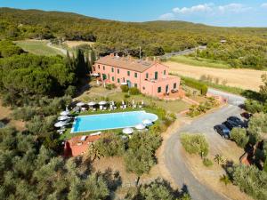 an aerial view of a house with a swimming pool at My Tuscany Suites in Castiglioncello