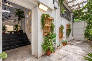 a building with plants on the side of it at Localz House- Trumpeldor Beach in Tel Aviv