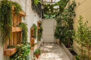 an alley with plants and a door in a building at Localz House- Trumpeldor Beach in Tel Aviv