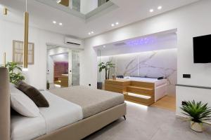 a bedroom with a king sized bed and a television at La Rocca D’Amuri in Partinico