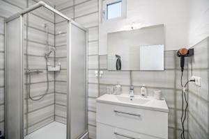 a bathroom with a shower and a sink and a mirror at Danma Ferienwohnung Apartment Eifel in Laubach +20 photos