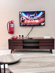 a living room with a tv on a wall at ايراد للشقق - النور in Dammam +5 photos