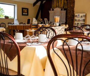 a dining room with a table and chairs at Hotel du Golf de Clécy in Clécy +31 photos
