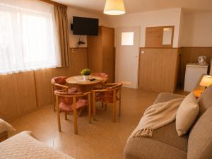 a living room with a table and chairs and a couch at DW Viva in Rewal