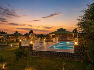 an image of a villa with a swimming pool at sunset at Jawai Garh Resort in Bīsalpur